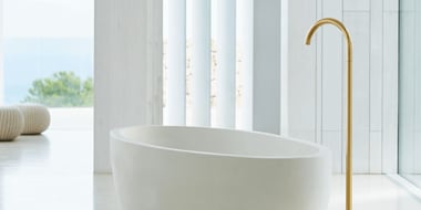 Bathtub with large gold faucet