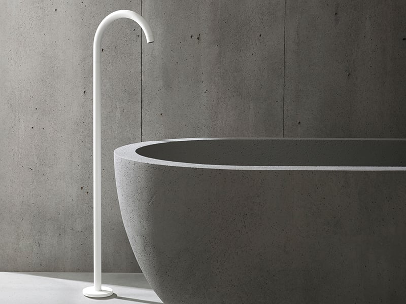 White freestanding floor-mounted tub filler with an arched neck