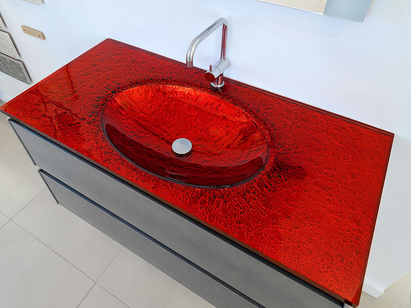 Red bathroom countertop with integrated basin