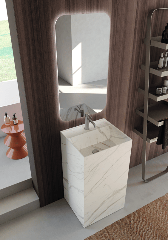 Marble pedestal sink in an updated luxury bathroom