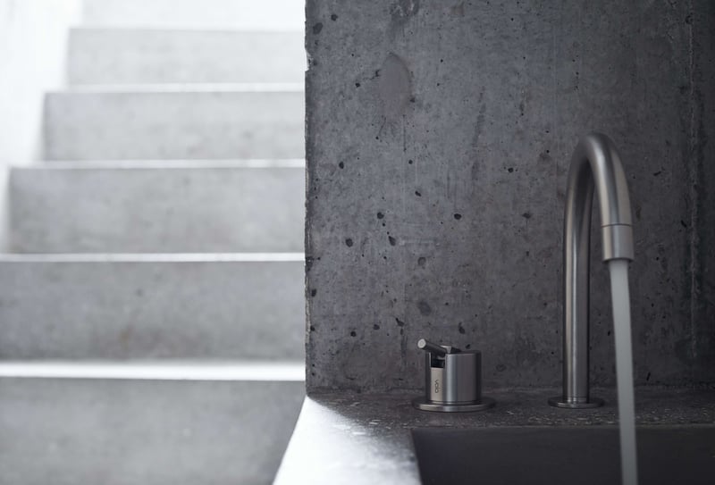 Deck mounted VOLA faucet in a luxury cement bathroom