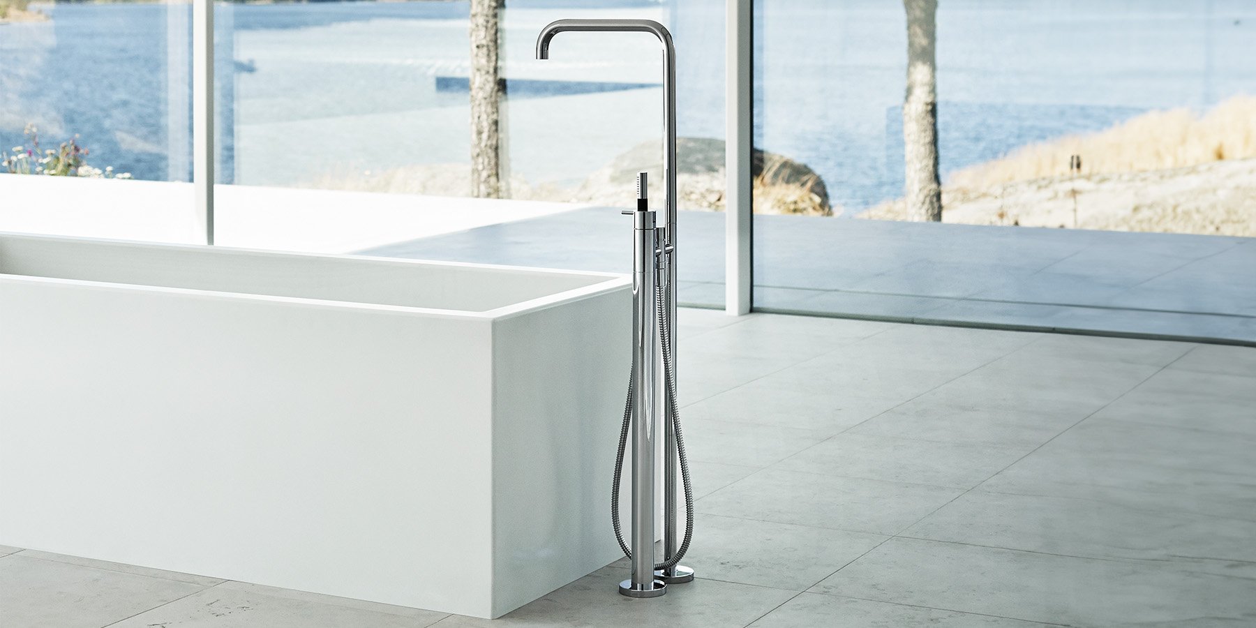 Chrome freestanding floor-mounted tub filler with a hand shower
